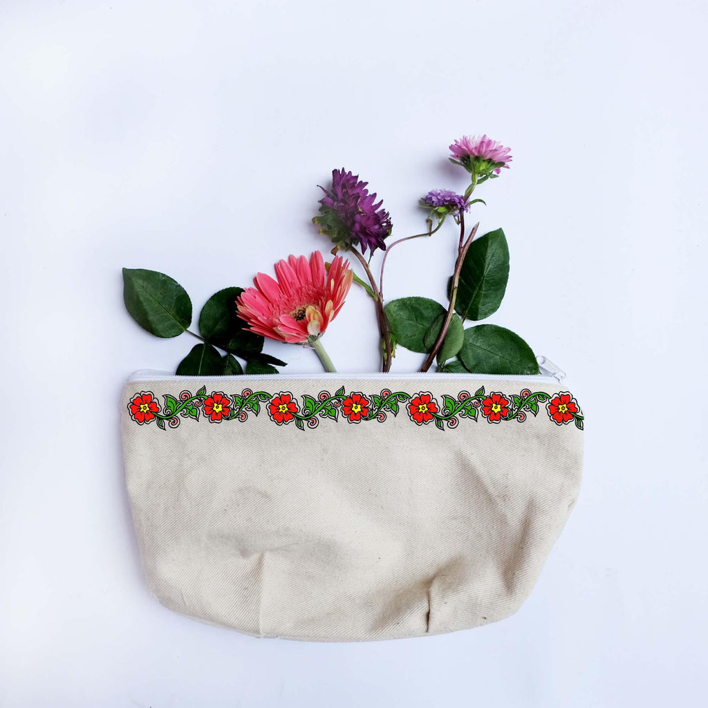 Cream canvas pouch with double line flower border painted in red and green with flowers. 